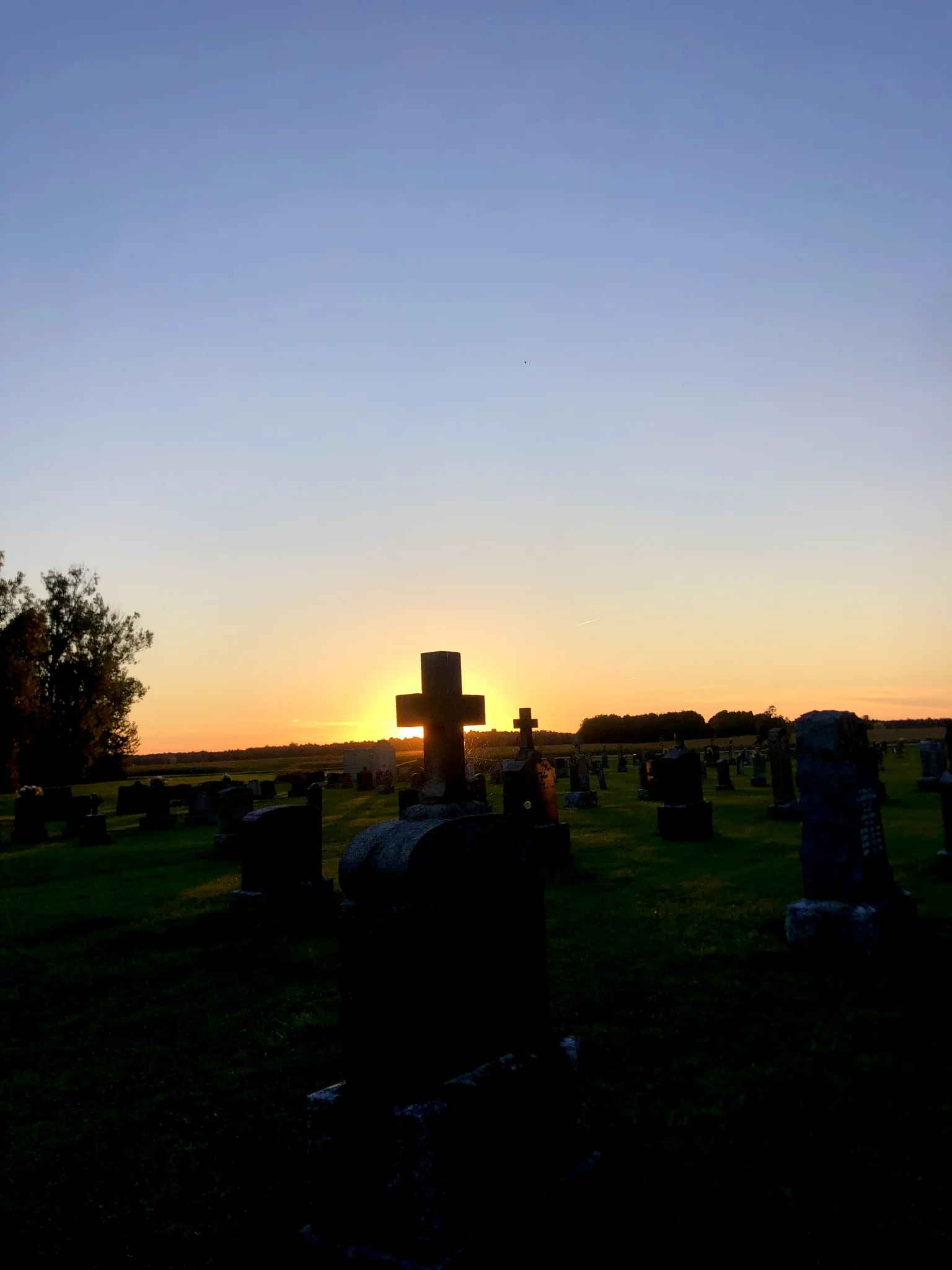 Sunset behind the gravestones of a hidden Northern Vermont cemetery