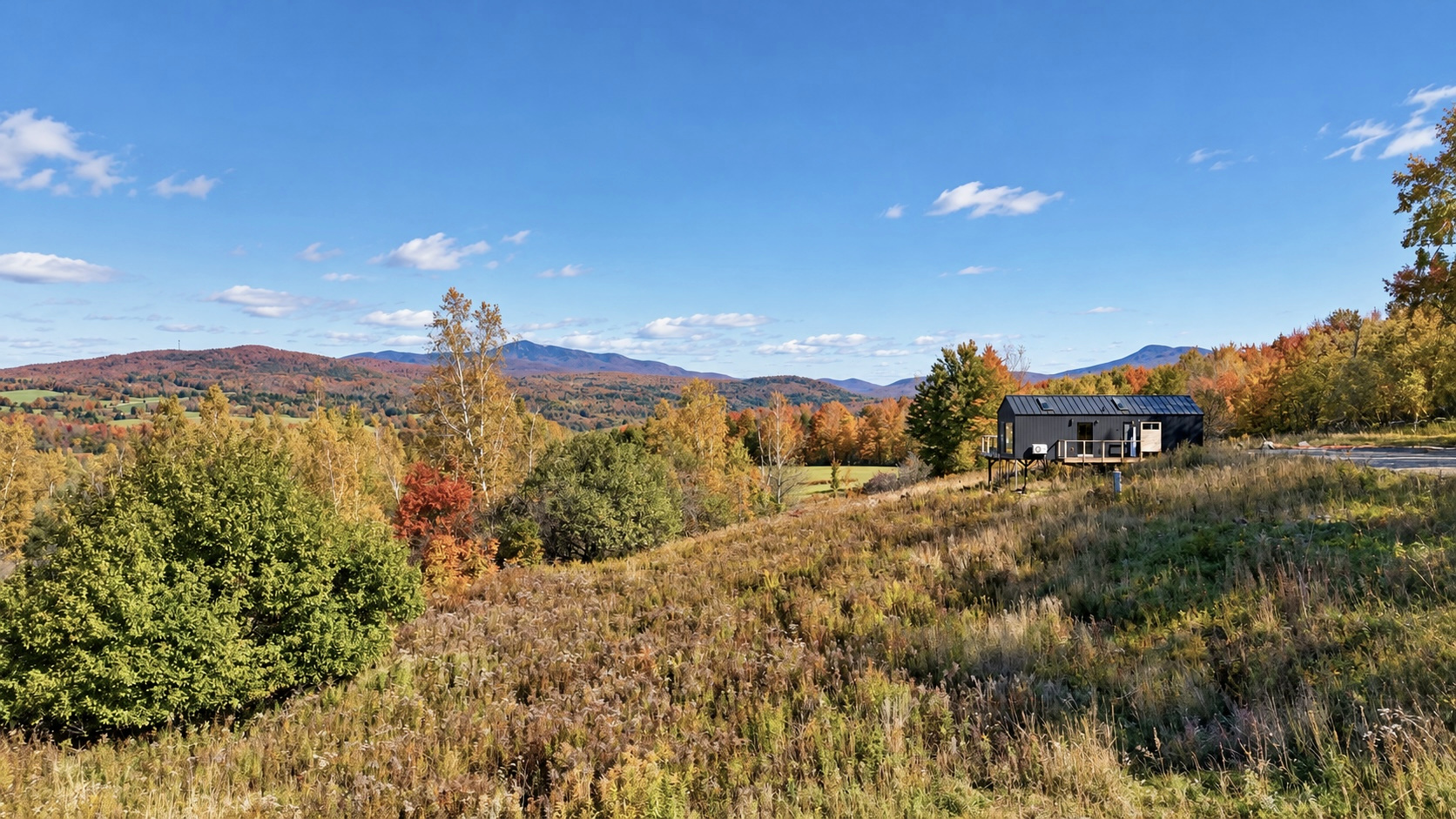 Maison Alice overlooking the autumn Missisquoi River Valley, with Mount Sutton to the left and Jay Peak to the right